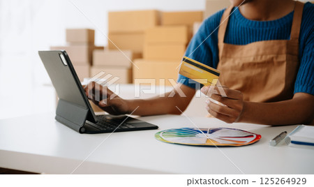 Woman Hand using tablet ,laptop, and holding mobile phone with credit card online banking payment communication network, internet application virtual icon Woman Hand using tablet ,laptop, and holding mobile phone with credit card online banking payment communication network, internet application virtual icon 125264929