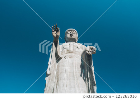 The huge Ushiku Buddha stands out against the blue sky 125265016