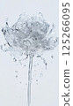 Water splashes form an intricate, abstract flower shape, capturing the fluid movements and ripples in stunning detail. The transparent water contrasts against a plain background 125266095