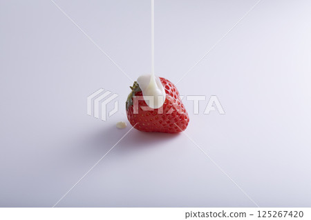 Condensed milk on strawberries 125267420