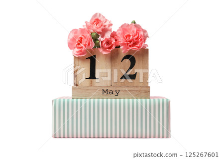 Floral arrangement with a wooden calendar highlighting May 12, isolated on white 125267601