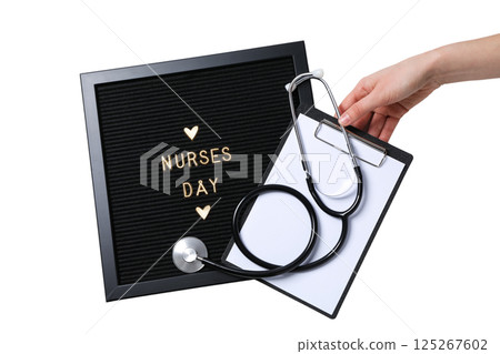 A hand holds a stethoscope and a clipboard next to a message board, isolated on white 125267602