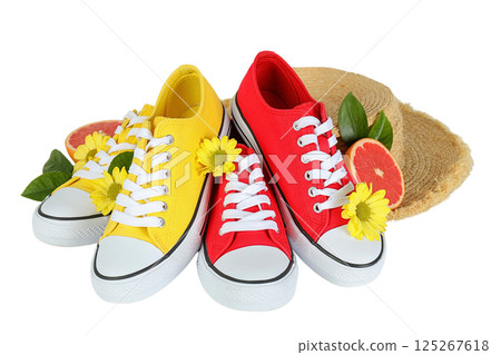Summer shoes, Bright yellow and red sneakers nestle among flowers, leaves, and a straw hat, summoning summer, isolated on white, PNG Summer shoes, Bright yellow and red sneakers nestle among flowers, leaves, and a straw hat, summoning summer, isolated on white, PNG 125267618