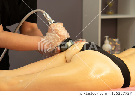 Close-up of RF device used on client's upper glute during session. 125267727