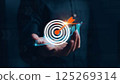 Businessman analyzing 2025 profit growth performance for the 2025-2026 financial plan. Image depicts market concepts, finance trends, revenue graphs, money, and profitability analysis for future 125269314