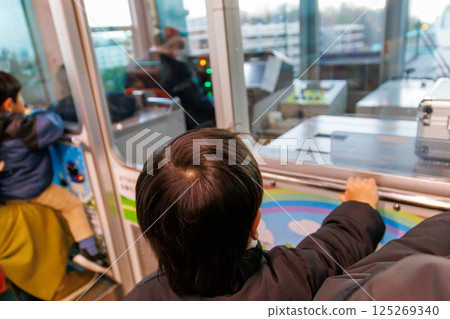 Toddler looking out from the train window Toddler looking out from the train window 125269340