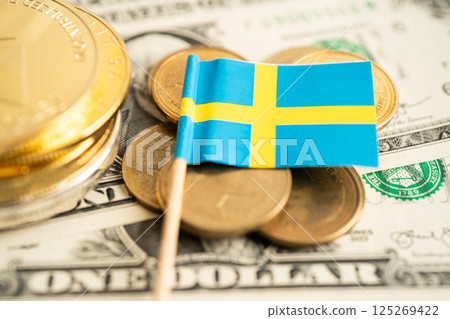 Stack of coins with Sweden flag and US dollar banknotes. 125269422