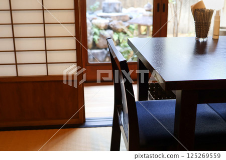 Tables, chairs and garden of a quaint old-fashioned cafe 125269559