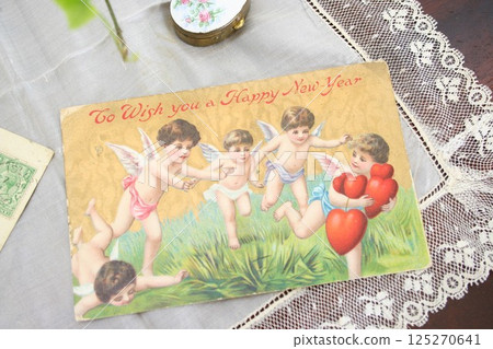 New Year's postcard of angels carrying hearts 125270641