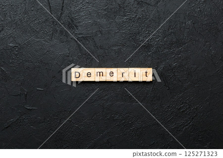 demerit word written on wood block. demerit text on table, concept demerit word written on wood block. demerit text on table, concept 125271323
