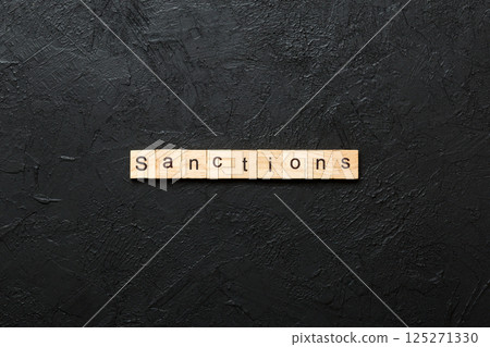 sanction word written on wood block. sanction text on table, concept sanction word written on wood block. sanction text on table, concept 125271330