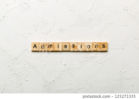 admissions word written on wood block. admissions text on table, concept 125271335