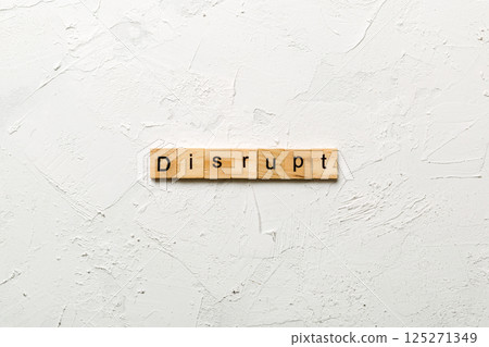 DISRUPT word written on wood block. DISRUPT text on cement table for your desing, concept DISRUPT word written on wood block. DISRUPT text on cement table for your desing, concept 125271349