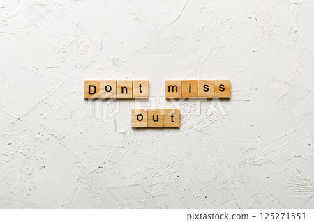 Don't miss out word written on wood block. Don't miss out text on cement table for your desing, Top view concept Don't miss out word written on wood block. Don't miss out text on cement table for your desing, Top view concept 125271351