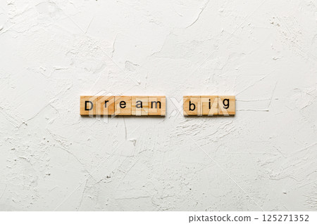 Dream big word written on wood block. Dream big text on cement table for your desing, Top view concept Dream big word written on wood block. Dream big text on cement table for your desing, Top view concept 125271352