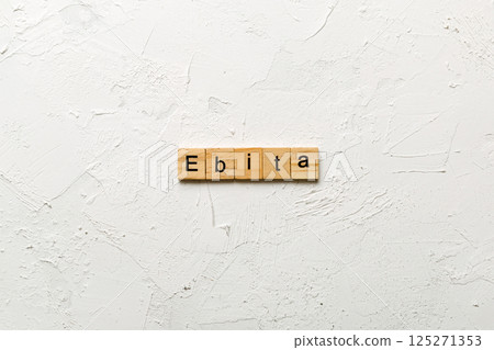 EBITA word written on wood block. EBITA text on cement table for your desing, concept 125271353