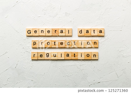 GDPR word written on wood block. General Data Protection Regulation text on cement table for your desing, concept 125271360