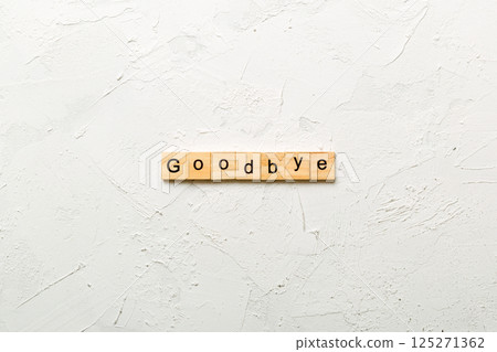 Goodbye word written on wood block. Goodbye text on table, concept Goodbye word written on wood block. Goodbye text on table, concept 125271362