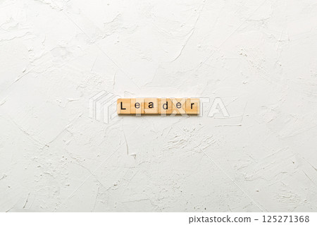 leader word written on wood block. leader text on cement table for your desing, concept 125271368