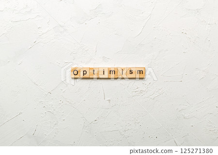 Optimism word written on wood block. Optimism text on cement table for your desing, concept 125271380