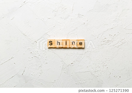 Shine word written on wood block. Shine text on cement table for your desing, concept Shine word written on wood block. Shine text on cement table for your desing, concept 125271390