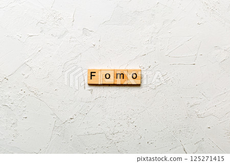 fomo word written on wood block. fomo text on table, concept fomo word written on wood block. fomo text on table, concept 125271415