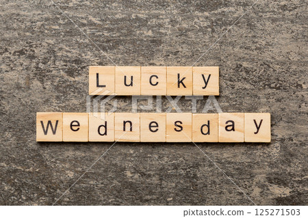 lucky wednesday word written on wood block. lucky wednesday text on cement table for your desing, concept lucky wednesday word written on wood block. lucky wednesday text on cement table for your desing, concept 125271503