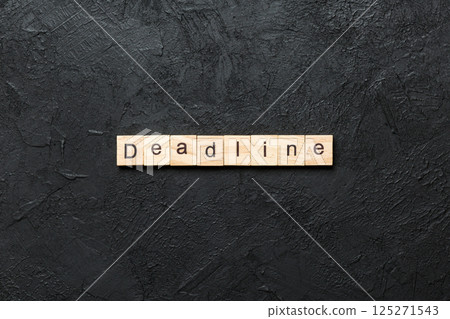 DEADLINE word written on wood block. DEADLINE text on cement table for your desing, concept 125271543