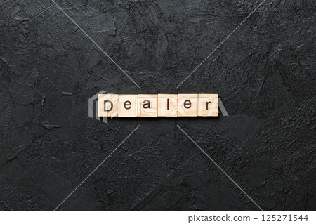Dealer word written on wood block. Dealer text on cement table for your desing, concept 125271544