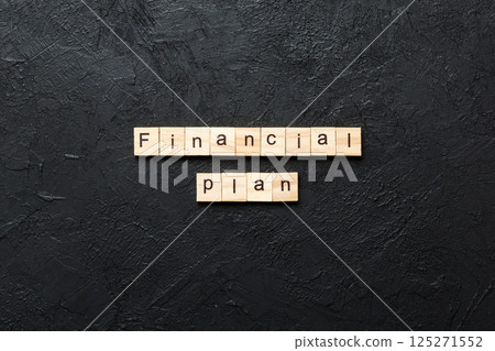 financial plan word written on wood block. financial plan text on cement table for your desing, concept 125271552