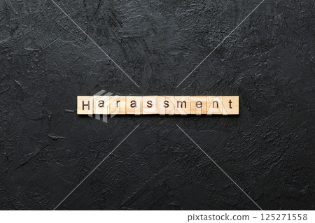 harassment word written on wood block. harassment text on cement table for your desing, concept 125271558