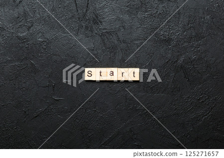 Start word written on wood block. Start text on cement table for your desing, concept Start word written on wood block. Start text on cement table for your desing, concept 125271657