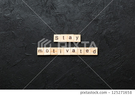 Stay motivated word written on wood block. Stay motivated text on cement table for your desing, concept 125271658