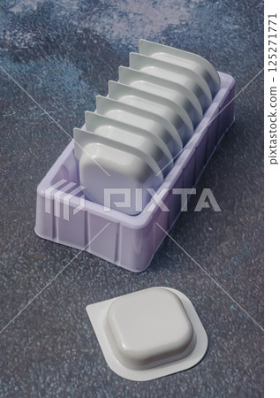Stack of single-use plastic containers for sauce or detergent. High quality photo 125271771