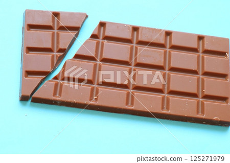 milk chocolate bar on blue background 125271979