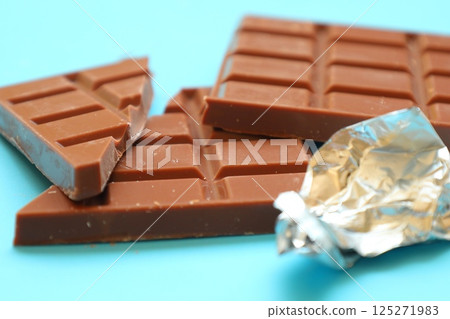 milk chocolate bar on blue background milk chocolate bar on blue background 125271983