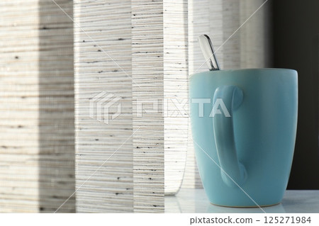 blue mug with spoon, close up blue mug with spoon, close up 125271984