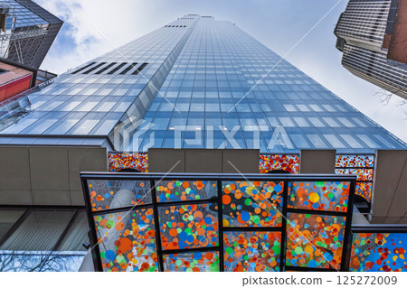 Modern Glass Skyscraper with Colorful Abstract Art Panels at the Entrance Modern Glass Skyscraper with Colorful Abstract Art Panels at the Entrance 125272009