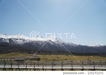Snow-covered Shiretoko mountain range, blue sky and promenade seen from the Shiretoko Five Lakes Snow-covered Shiretoko mountain range, blue sky and promenade seen from the Shiretoko Five Lakes 125272231