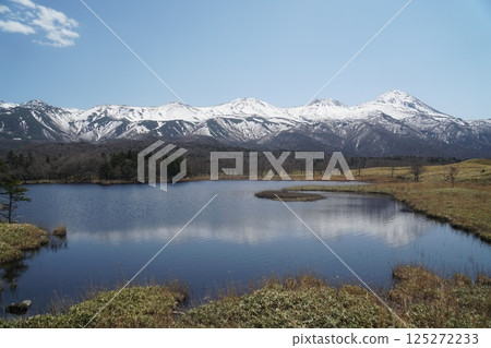 The snow-covered Shiretoko mountain range and the lakes reflecting it as seen from the Shiretoko Five Lakes The snow-covered Shiretoko mountain range and the lakes reflecting it as seen from the Shiretoko Five Lakes 125272233