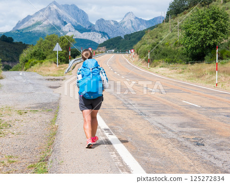 Lonely Pilgrim with backpack walking the Camino de Santiago, ruta Vadiniense. Way of St James Lonely Pilgrim with backpack walking the Camino de Santiago, ruta Vadiniense. Way of St James 125272834