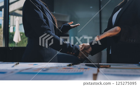 Business success. Business people shaking hands agreement confirmed in the investment business. Business success. Business people shaking hands agreement confirmed in the investment business. 125275095