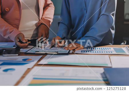 Business analyze,Close up Business people meeting to discuss the situation on the market. Business Financial Concept 125275128