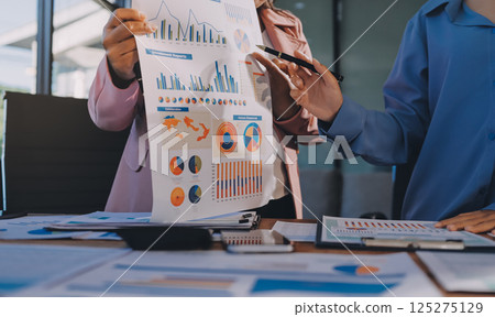 Business analyze,Close up Business people meeting to discuss the situation on the market. Business Financial Concept 125275129