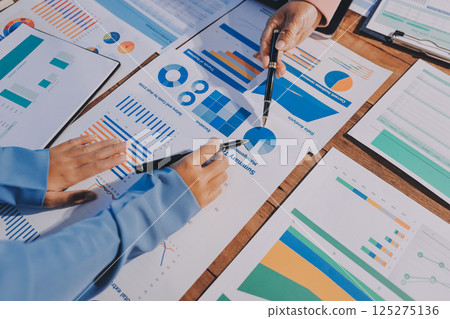 Business analyze,Close up Business people meeting to discuss the situation on the market. Business Financial Concept 125275136