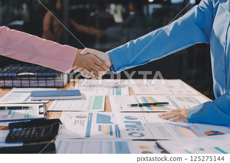 Business success. Business people shaking hands agreement confirmed in the investment business. Business success. Business people shaking hands agreement confirmed in the investment business. 125275144