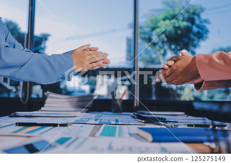 Team of businesspeople clapping hands while having a conference. Business professionals applauding at a seminar. 125275149