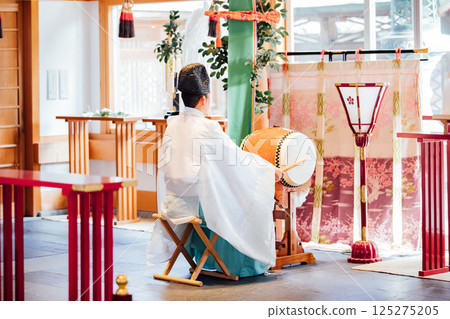Praying at the shrine 125275205
