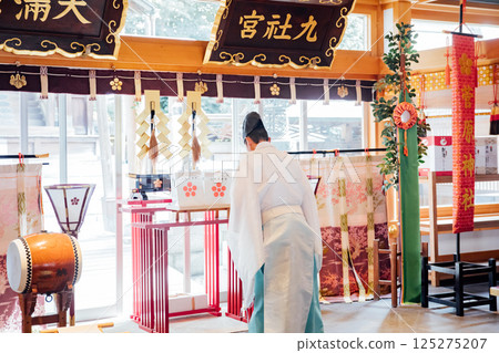 Praying at the shrine 125275207