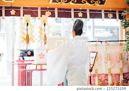 Praying at the shrine 125275209